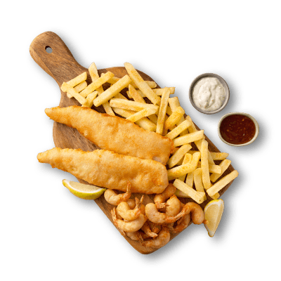 Golden battered fish fillets served with french fries, fried shrimp, lemon wedges, and dipping sauces on a wooden board.