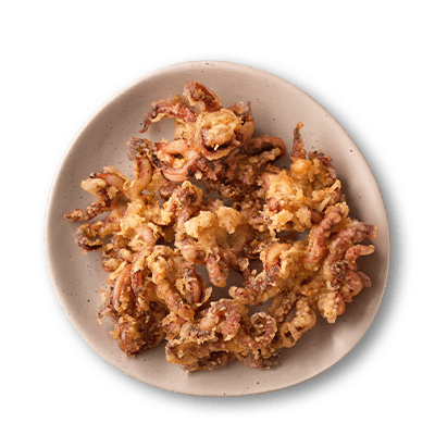 Squiggly pops squid heads in a white bowl