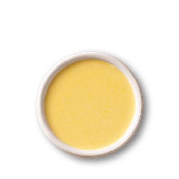 Creamy lemon sauce in white bowl