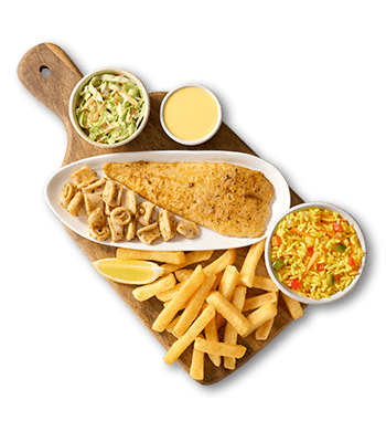 Crispy fried fish, calamari, golden french fries, yellow rice, coleslaw, and dipping sauce served on a wooden board.