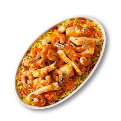 Vibrant seafood and yellow rice dish in an oval white bowl. Features plump shrimp, white fish fillets, and other seafood in a rich red sauce.