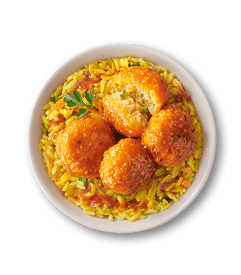 White bowl of vibrant yellow rice with red sauce, topped with four golden-orange glazed veggie bites.